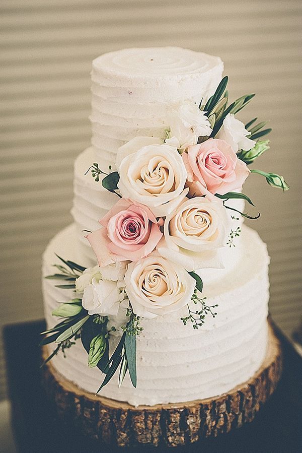 simple buttcream wedding cake with white and pink roses
