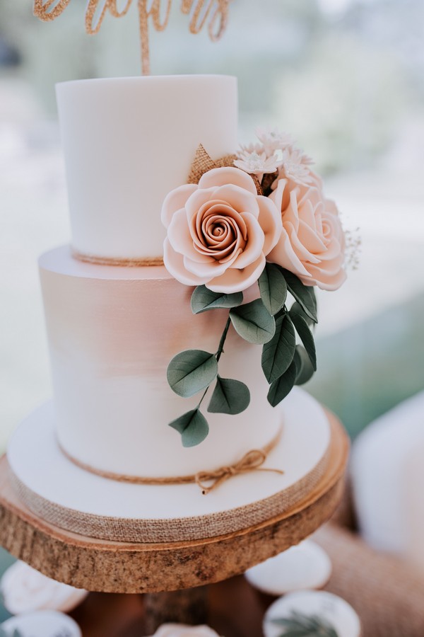 simple pink ombre wedding cake with flower detail