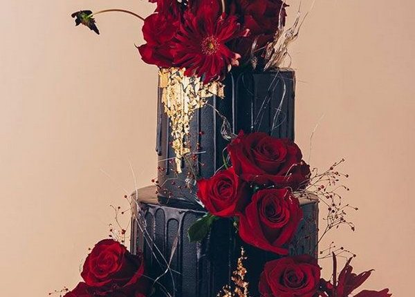 black wedding cake with red roses