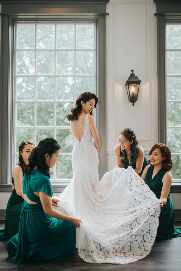 bride getting ready with bridesmaids gown
