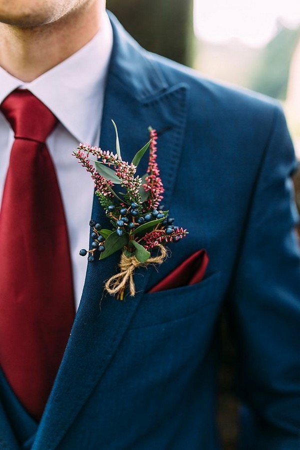 navy fall and winter groom wedding suit and burgundy boutonniere
