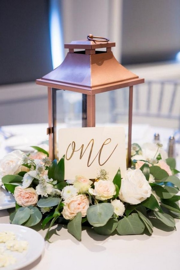 rose gold lantern and roses eucalyptus wedding centerpiece