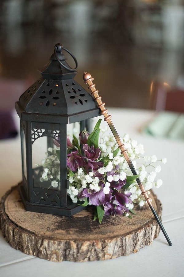 rustic tree stump and black lantern wedding centerpiece