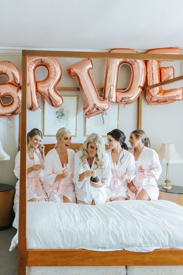 bride getting ready with bridesmaids gown