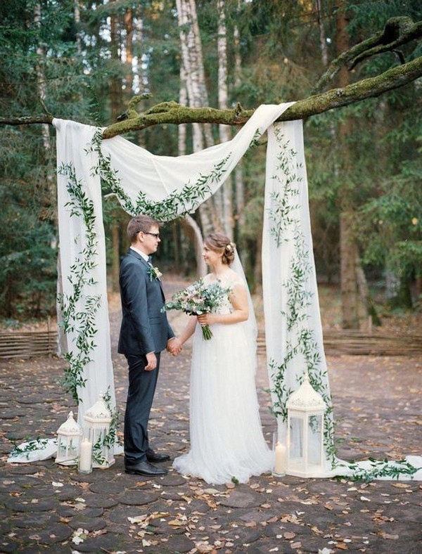 wedding altar ideas with drapery and lanterns hung on a tree