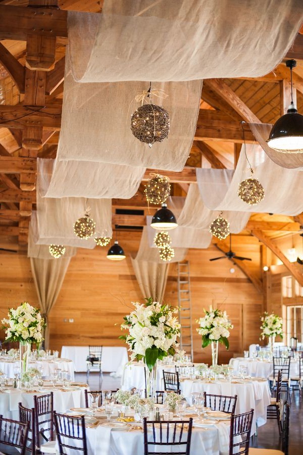 vintage barn wedding reception with draping fabric and lighting