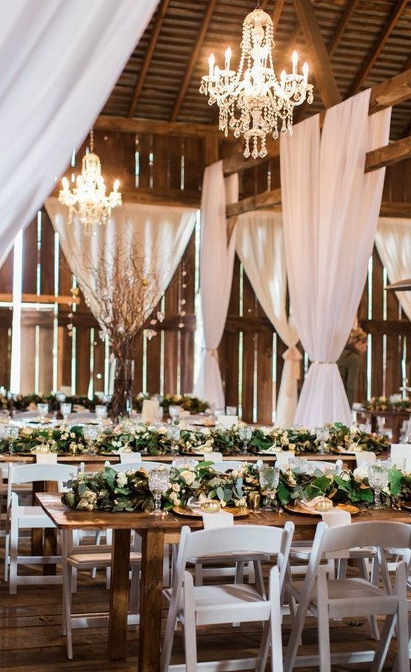wedding reception with white draping in a barn